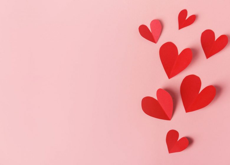 Paper valentines day hearts on pink